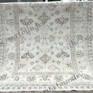 Hand Knotted Ivory Oushak Rug: Pale Blue Floral Turkish Wool Carpet