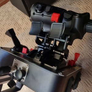 May include: Black flight simulator pedals with red buttons and a black control panel with USB and AUX ports.