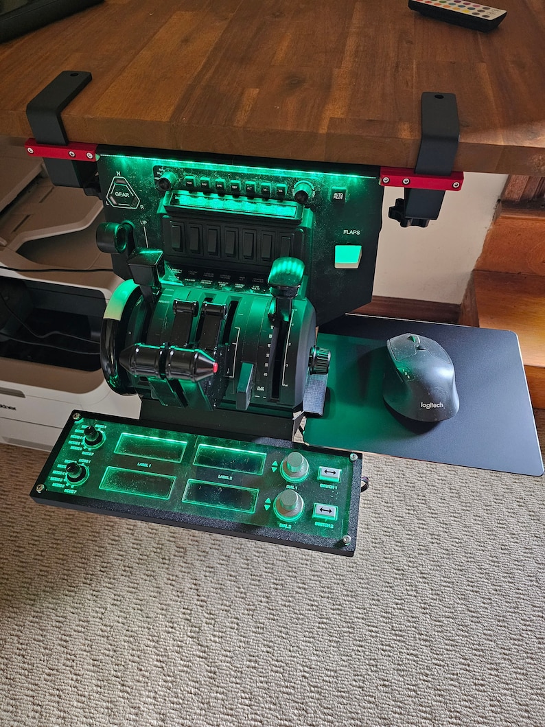 May include: A black flight simulator control panel with green LED lighting, mounted under a wooden surface. Features include levers, switches, and a throttle quadrant. A Logitech mouse and mousepad are visible.