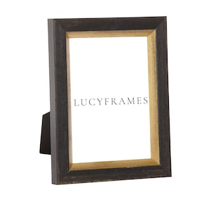 Kenya Black and Gold Frame. Modern Frame Style. All Wood Frames. Wedged Picture Frame. Different Wood Frames. Thin Solid Wood Frame.
