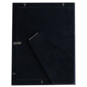 May include: Black picture frame with a black mat and a stand on the back.