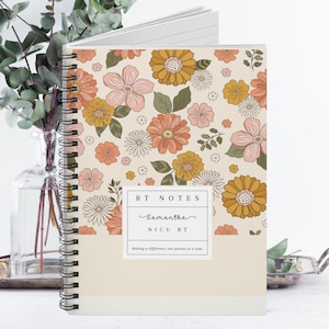 May include: A spiral bound notebook with a floral pattern in shades of pink, yellow, and green. The cover has a white label with the text "RT NOTES", "Samantha", "NICU RT", and "Making a difference, one patient at a time."