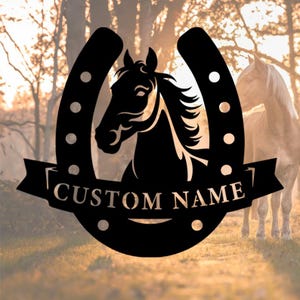 May include: Black metal horse head silhouette inside a horseshoe with the text "CUSTOM NAME" on a banner. The background features a blurred image of a horse and a forest.