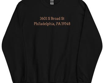 May include: Black sweatshirt with the text "3601 S Broad St Philadelphia, PA 19148" printed in orange on the front.
