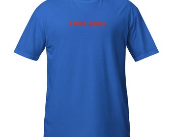 May include: A royal blue t-shirt with short sleeves. The text "1969-2004" is printed in red across the chest. The shirt is made of a soft, comfortable material.