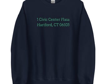 May include: Navy blue sweatshirt with the text "1 Civic Center Plaza Hartford, CT 06103" printed in green.