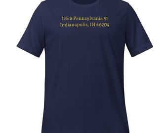 May include: Navy blue t-shirt with the text "125 S Pennsylvania St Indianapolis, IN 46204" printed in gold. The shirt is a short-sleeved crew neck style.