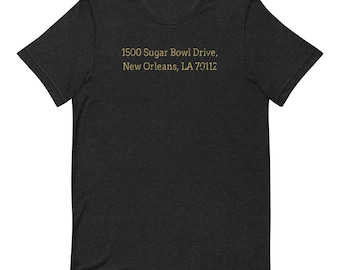 May include: Black t-shirt with the text "1500 Sugar Bowl Drive, New Orleans, LA 70112" printed in gold.