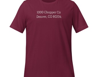 May include: Burgundy t-shirt with white text that reads "1000 Chopper Cir Denver, CO 80204"