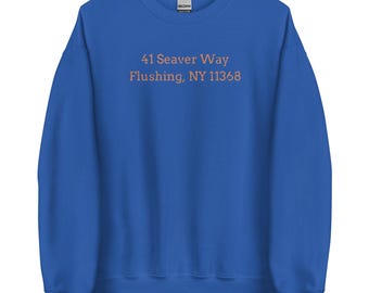 May include: Royal blue sweatshirt with the text "41 Seaver Way Flushing, NY 11358" printed in orange.