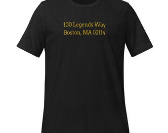 May include: Black t-shirt with the text "100 Legends Way Boston, MA 02114" printed in gold.