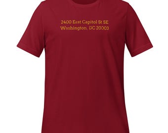 May include: A red t-shirt with the text "2400 East Capitol St SE Washington, DC 20003" printed in yellow on the front.