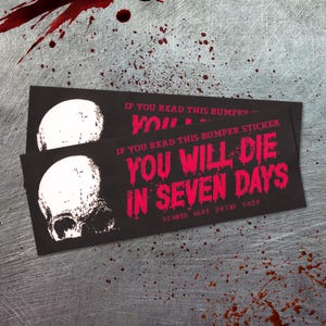 May include: Two black bumper stickers with a white skull graphic and red text that reads "IF YOU READ THIS BUMPER STICKER YOU WILL DIE IN SEVEN DAYS." The stickers are from Scared Hare Print Shop.