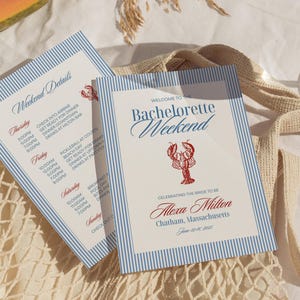 May include: Two invitation cards with blue and white stripes. The cards read "Welcome to the Bachelorette Weekend" with a red lobster illustration. The cards also include the name "Alexa Milton" and event details.