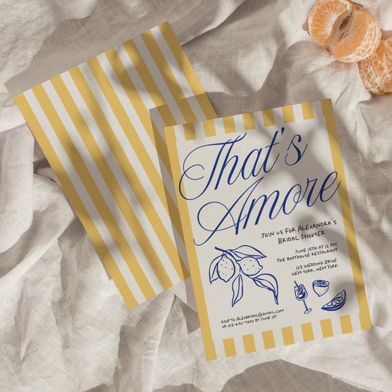 May include: Two bridal shower invitations with yellow and white striped borders. The main invitation reads "That's Amore" in elegant blue script, with event details and lemon illustrations. A few mandarin orange slices are in the background.