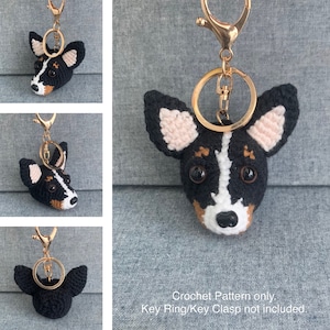 May include: Crochet pattern for a black, white, and brown dog keychain. The dog has pink ears and black eyes. The keychain is attached to a gold key ring. Crochet Pattern only. Key Ring/Key Clasp not included.