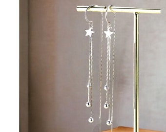Hangende zilveren kettingoorbellen met stervormige draad in minimalistische stijl. Cadeau-idee voor damessieraden
