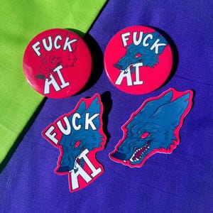 May include: Red round badges and stickers featuring a blue wolf graphic and the text "FUCK AI" in white. The wolf has red eyes and is set against a red background. The stickers are die-cut.