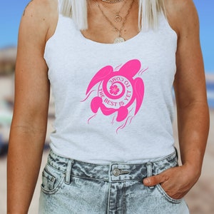 Puede incluir: Camiseta blanca de tirantes con un gráfico rosa de una tortuga marina con el texto "Come to the best is yet" dentro del caparazón de la tortuga.