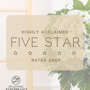 May include: A beige graphic with the words "HIGHLY ACCLAIMED FIVE STAR RATED SHOP" and five gold stars. The graphic is in front of a bouquet of white and green flowers and a wooden stand. The logo "IN LOVING REMEMBRANCE" is at the bottom.