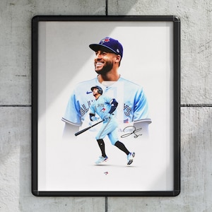 May include: Framed print featuring a baseball player in a light blue uniform and cap with the team logo. The image includes a larger portrait of the player and a smaller action shot, with the player holding a bat.