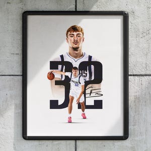 May include: Framed print of a basketball player in a white and blue uniform, holding a basketball. The number 32 is displayed. The image includes a signature and a background image of the player.