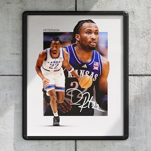 May include: Framed print featuring a basketball player in a blue and white uniform with the word "KANSAS" on the jersey. The image includes a signature and the number 22. The background is a light gray.
