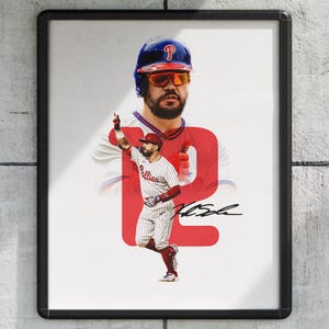 May include: Framed print featuring a baseball player in a Phillies uniform. The image includes a portrait of the player, a large red "P" graphic, and the player's signature. The player is wearing a helmet and sunglasses.