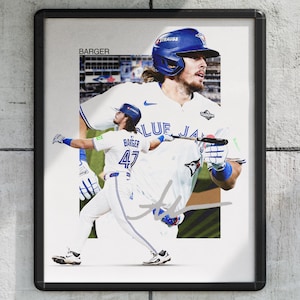 May include: Framed print of a baseball player in a Blue Jays uniform. The image shows the player in action, with the name "BARGER" and the number "47" visible. The player is wearing a blue helmet and holding a bat.
