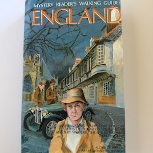 May include: A book titled Mystery Reader's Walking Guide: England, featuring an illustration of a person in a tan hat and jacket, a vintage green car, and a street scene. The cover includes the text 14 Fascinating Walks That Follow The Paths Of The Most Widely Read Mystery Writers, Their Sleuths And Characters by Alzina Stone Dale and Barbara Sloan Hendershott.