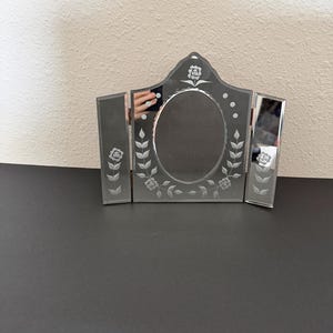 May include: A set of three ceramic mugs with a speckled, matte finish. The mugs are in shades of cream, light gray, and dark gray. Each mug has a simple, minimalist design, perfect for coffee or tea.