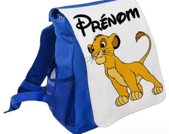 Könnte beinhalten: Blau-weißer Rucksack mit einer Löwenfigur und dem Wort "PRÉNOM" auf der Vorderseite.
