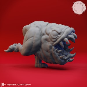 May include: A 3D-printed, light gray monster figurine with sharp teeth and a menacing expression. The creature has a bulky body, small legs, and a tail. The background is a solid red. The text "YASASHIIKYOJINSTUDIO" is at the bottom.