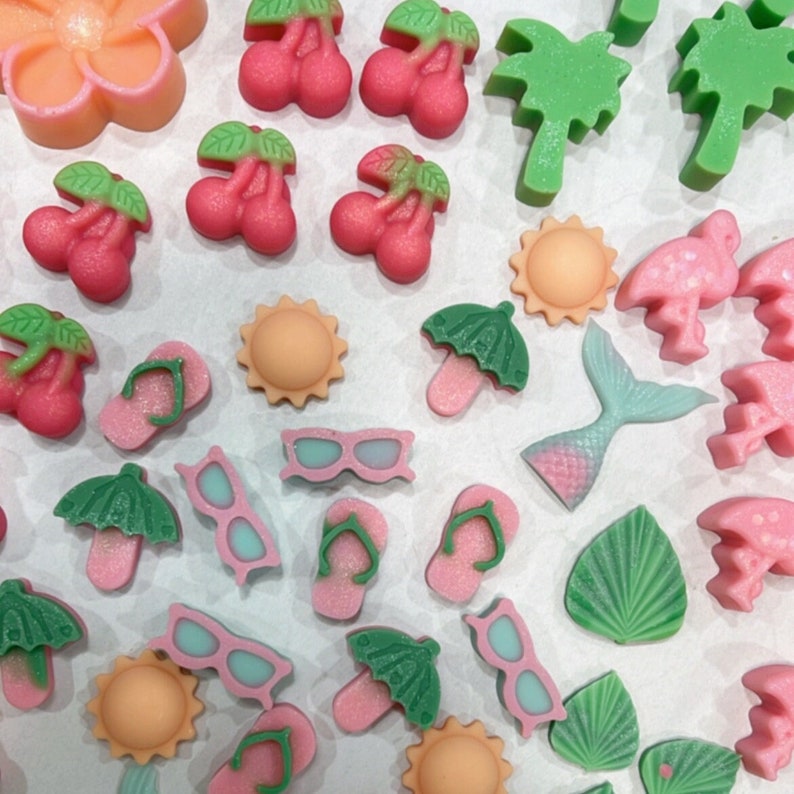 May include: Assortment of colorful, handmade, polymer clay charms with summer themes.  The charms include flip flops, sunglasses, palm trees, flowers, and umbrellas.
