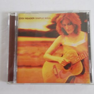 May include: A CD case with a photo of a woman playing a guitar. The text on the case reads "Eddi Reader Simple Soul".