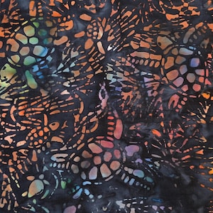 May include: A black fabric with a batik pattern of orange, blue, and purple. The pattern is made up of small, intricate shapes that resemble flowers or leaves.