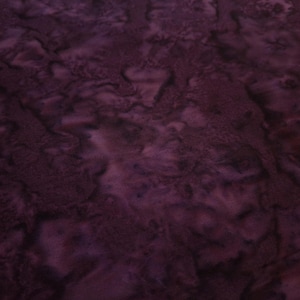 May include: Purple fabric with a mottled, tie-dye pattern. The fabric has a soft, textured feel.