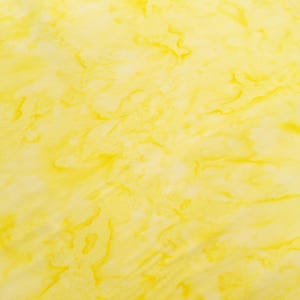 May include: A yellow background with a marbled pattern. The background is a light yellow with darker yellow swirls and streaks.
