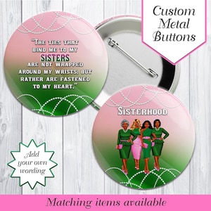 May include: Custom metal buttons with pink and green designs. One button features the text "The ties that bind me to my sisters..." Another button displays the word "Sisterhood" and illustrations of women in green and pink dresses.