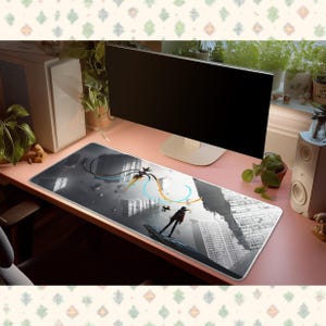 May include: A rectangular desk mat featuring a black and white graphic illustration of a figure standing amidst a surreal cityscape with floating structures and abstract orange and blue swirling lines across the surface of the mat.