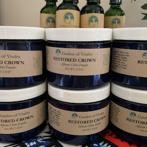 May include: Six blue jars with white lids containing a product labelled "Restored Crown African Chebe Powder" with a net weight of 2.5 oz. The jars are arranged in two rows of three.