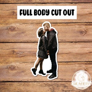 May include: A couple kissing, the woman is wearing a black leather jacket and a black skirt, the man is wearing a black jacket and black pants.  Full body cut out.