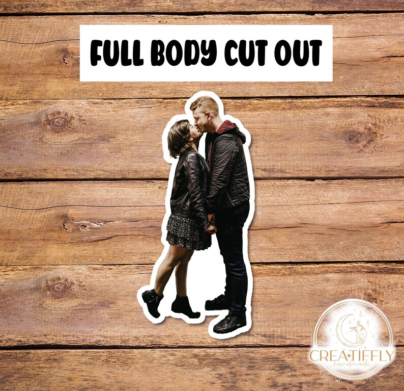 May include: A couple kissing, the woman is wearing a black leather jacket and a black skirt, the man is wearing a black jacket and black pants.  Full body cut out.