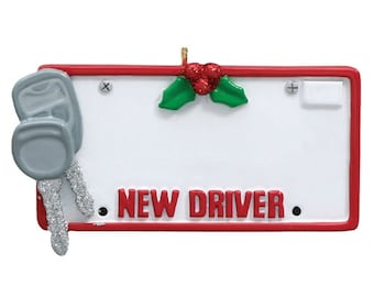 May include: Red and white Christmas ornament shaped like a license plate with a silver car key and the words "NEW DRIVER" on it.