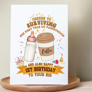 May include: A white greeting card featuring a baby bottle and a coffee cup with the text Cheers to surviving the first year of parenthood and also happy 1st birthday to your kid, decorated with a small cake, confetti, and party hats.