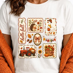May include: A white t-shirt featuring a graphic print with the text hello fall, a hedgehog, a goose wearing a hat and scarf, a red tractor, a basket of pumpkins and sunflowers, a plaid bow, and autumn leaves in various rectangular frames.