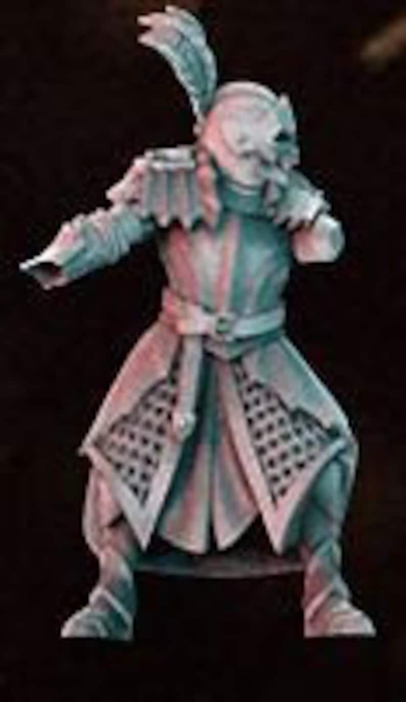 May include: A miniature figurine of a warrior wearing a helmet with a feather, chainmail armor, and a long, flowing cloak. The figure is painted in shades of blue and green.