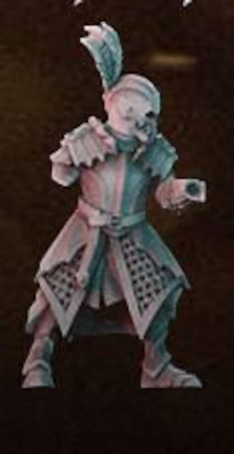 May include: A skeletal figure wearing a red and green costume with a feathered hat and holding a small object in its hand. The figure is painted in a realistic style and appears to be a miniature figurine.