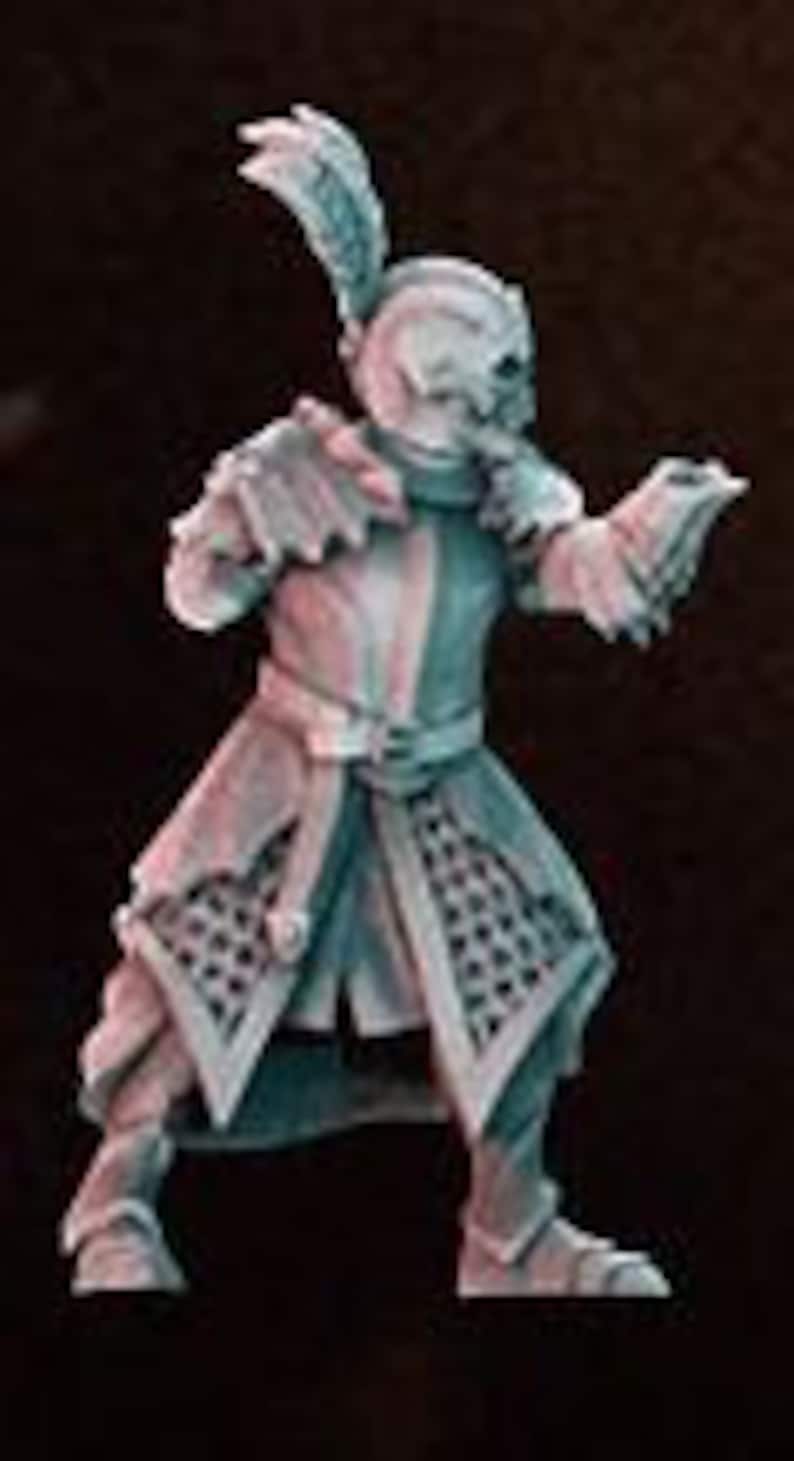May include: A miniature figurine of a goblin wearing a helmet and chainmail armor, holding a sword and shield. The goblin is painted in shades of green and brown.
