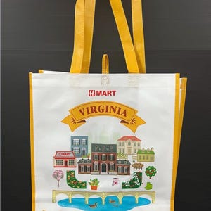 May include: White tote bag with yellow handles and trim. The bag features a colorful illustration of buildings and a bridge, with the text "VIRGINIA" and "H Mart, America's Asian Supermarket."